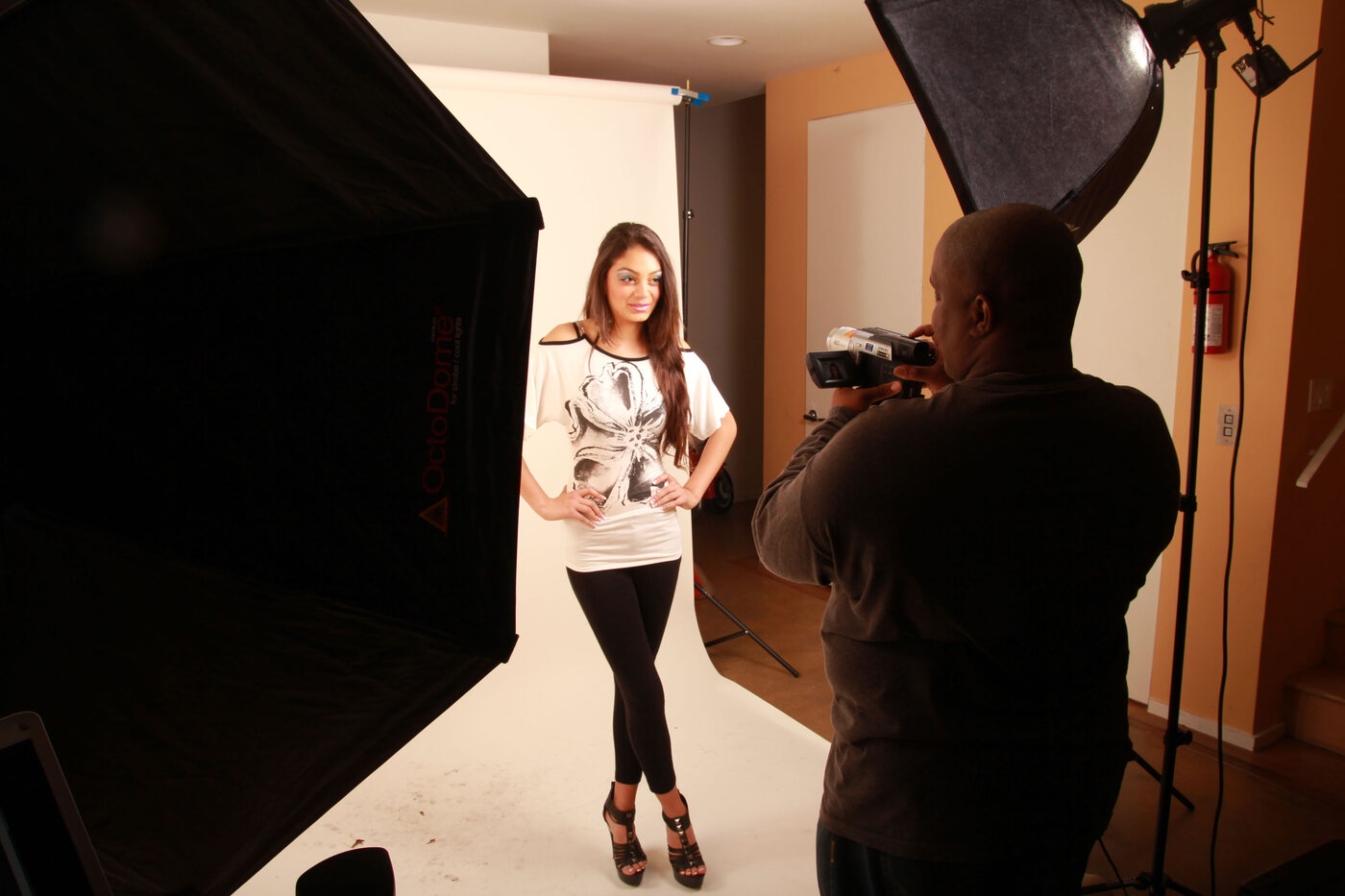Big Rick photographing a model on white seamless between two OctoDome softboxes